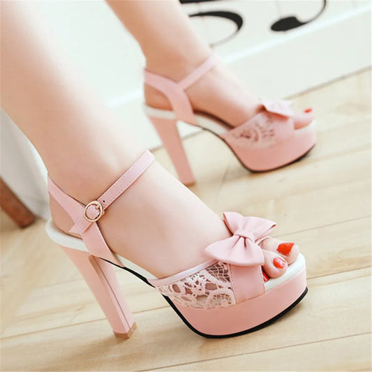 Pink open toe high heels with cute lacy mesh and a feminine bow. Perfect for trans girls, crossdressing, non binary and gender non conforming people.